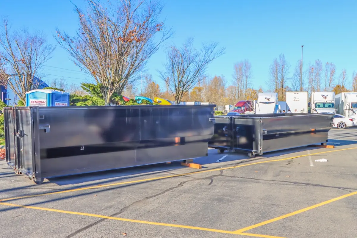 Professional dumpster rental service with roll-off container on residential driveway in Middleborough